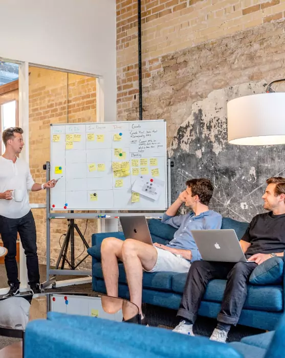 A business team analyzing the business goals, data and scalability on white board