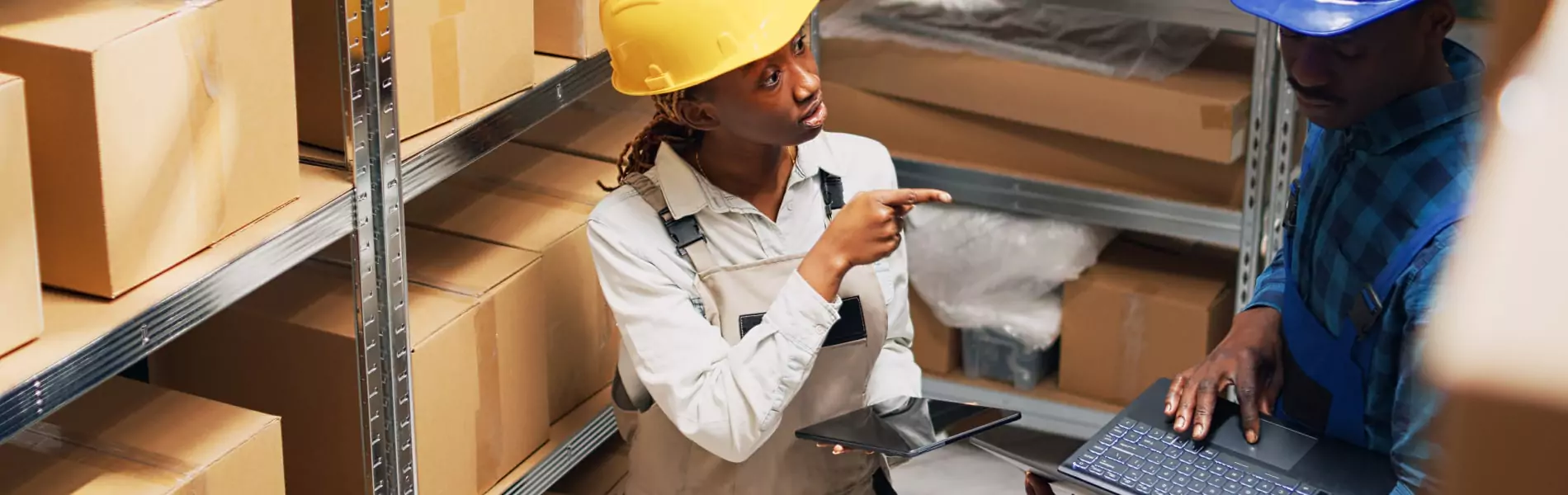 Logistics company employees working on laptop and managing stock through software