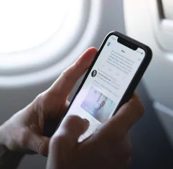 Image of person’s hand holding phone