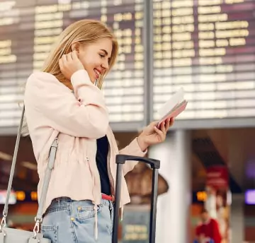 A female smiling while taking documents in hand